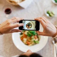 woman taking overhead photo of dinner - food stock pictures, royalty-free photos & images
