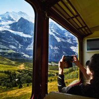 woman taking photo with smartphone of jungfrau while riding in train - travel stock pictures, royalty-free photos & images