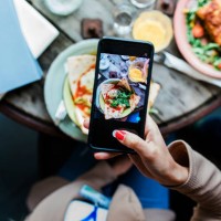 woman taking pics of food using smartphone - food stock pictures, royalty-free photos & images