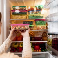 woman taking raw food from refrigerator - food stock pictures, royalty-free photos & images