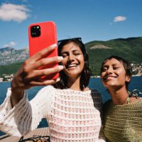 woman taking selfie with female friend on smart phone - travel stock pictures, royalty-free photos & images