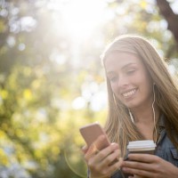 woman texting on her phone at the park - junk food stock pictures, royalty-free photos & images