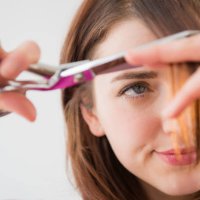 woman trimming her bangs - hairstyle stock pictures, royalty-free photos & images