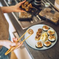 woman unpacking takeaway sushi at home - junk food stock pictures, royalty-free photos & images