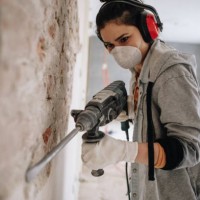 woman using drilling machine during reconstruction of her apartment - home decoration stock pictures, royalty-free photos & images