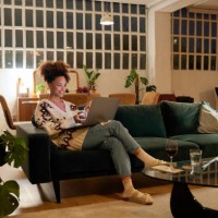 woman using laptop on sofa in living room - home decoration stock pictures, royalty-free photos & images