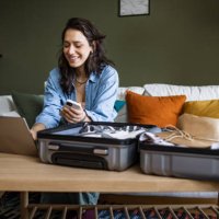 woman using laptop to book travel reservation - travel stock pictures, royalty-free photos & images