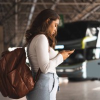 woman waiting for bus at the bus station - travel stock pictures, royalty-free photos & images