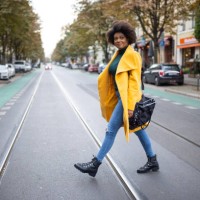 woman walking across the street - fashion stock-fotos und bilder