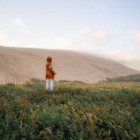 woman walking among big sand dunes during extreme weather - fashion stock pictures, royalty-free photos & images