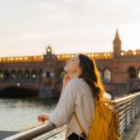 woman walking in berlin at sunset near oberbaumbrucke bridge - travel stock pictures, royalty-free photos & images