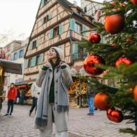 woman walking near the christmas tree in city centre - travel stock pictures, royalty-free photos & images