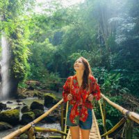 woman walking near the refreshing waterfall on bali - travel stockfoto's en -beelden