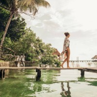 woman walking on a pier at a lagoon - fashion stock pictures, royalty-free photos & images