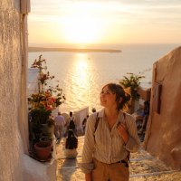 woman walking on streets on santorini island at sunset - travel stock pictures, royalty-free photos & images