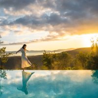 woman walking on the edge of infinity pool - travel stock pictures, royalty-free photos & images
