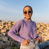 woman wearing sunglasses standing outside smiling - fashion stock pictures, royalty-free photos & images