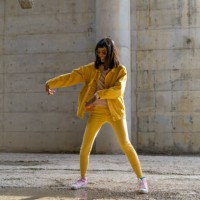 woman wearing yellow jeans clothes, dancing - fashion stock pictures, royalty-free photos & images