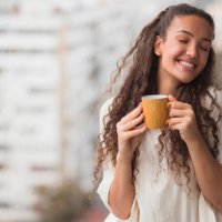 woman with closed eyes enjoying a cup of coffee - coffee stock pictures, royalty-free photos & images