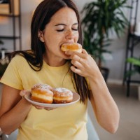 woman with donuts - junk food stock pictures, royalty-free photos & images