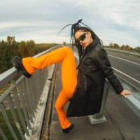 woman with dreadlocks in black coat on bridge. street style. - fashion stock pictures, royalty-free photos & images