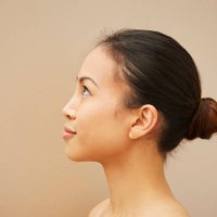 woman with hair bun - hairstyle fotografías e imágenes de stock