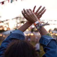 woman with hands raised dancing at music festival - concert stock pictures, royalty-free photos & images