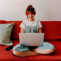 woman with headphones working on laptop in living room - home decoration stock pictures, royalty-free photos & images
