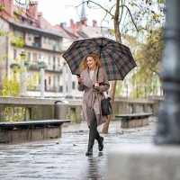 woman with umbrella walking down the street - fashion stock pictures, royalty-free photos & images