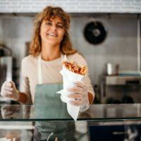 woman works in a fast food shop - junk food stock pictures, royalty-free photos & images