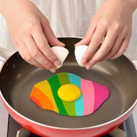 women bake in a frying pan colorful egg - food stock pictures, royalty-free photos & images