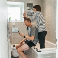 women cutting partner's hair in the bathroom - hairstyle stock pictures, royalty-free photos & images