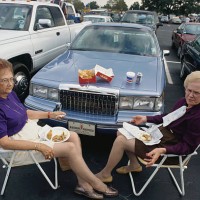women eating at tailgate party - junk food stock pictures, royalty-free photos & images