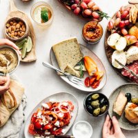 women eating fresh mediterranean platter on table - food stock pictures, royalty-free photos & images