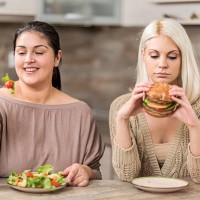 women eating in the kitchen. - junk food stock pictures, royalty-free photos & images