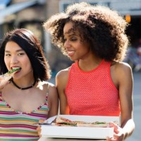 women eating pizza from box outdoors - junk food stock pictures, royalty-free photos & images