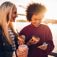 women using phone - junk food stock pictures, royalty-free photos & images