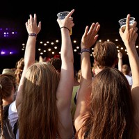 women with raised hands holding beer at concert - concert stock pictures, royalty-free photos & images