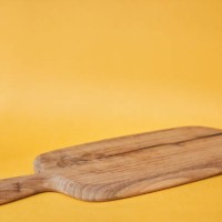 wooden cutting board on the yellow background. mock up for your design. product display for your food product with copy space. - food stock pictures, royalty-free photos & images