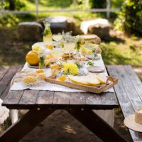 wooden picnic table decorated with various food in garden - garden decoration stock pictures, royalty-free photos & images