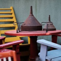 wooden table with vintage chairs and rusty metal funnels - garden decoration stock pictures, royalty-free photos & images