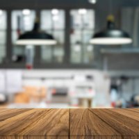 wooden tabletop over defocused kitchen background - food stock pictures, royalty-free photos & images
