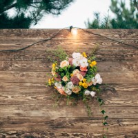 wooden wedding backdrop with light garland and flower arrangement - garden decoration stock pictures, royalty-free photos & images