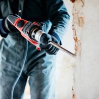 worker using pneumatic hammer drill to cut the wall concrete brick, close up - home decoration stock pictures, royalty-free photos & images