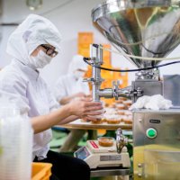 workers in a food processing factory packaging food - food stock pictures, royalty-free photos & images