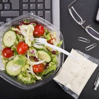 workplace with mixed salad on laptop - junk food stock pictures, royalty-free photos & images
