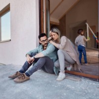 worried parents relaxing on the door of their new home. - home decoration stock pictures, royalty-free photos & images