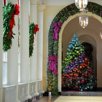 Wreaths of pine and stained glass cover windows in a long hallway leading to the East Garden room as the First Lady welcomes military families to...