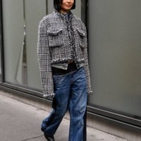 Yan Yan Chan is seen wearing a gray tweed Sacai jacket, blue Sacai jeans and black shoes outside the Sacai show during Womenswear Spring/Summer 2025...