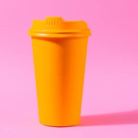 yellow coffee cup against colorful pink background - junk food stock pictures, royalty-free photos & images